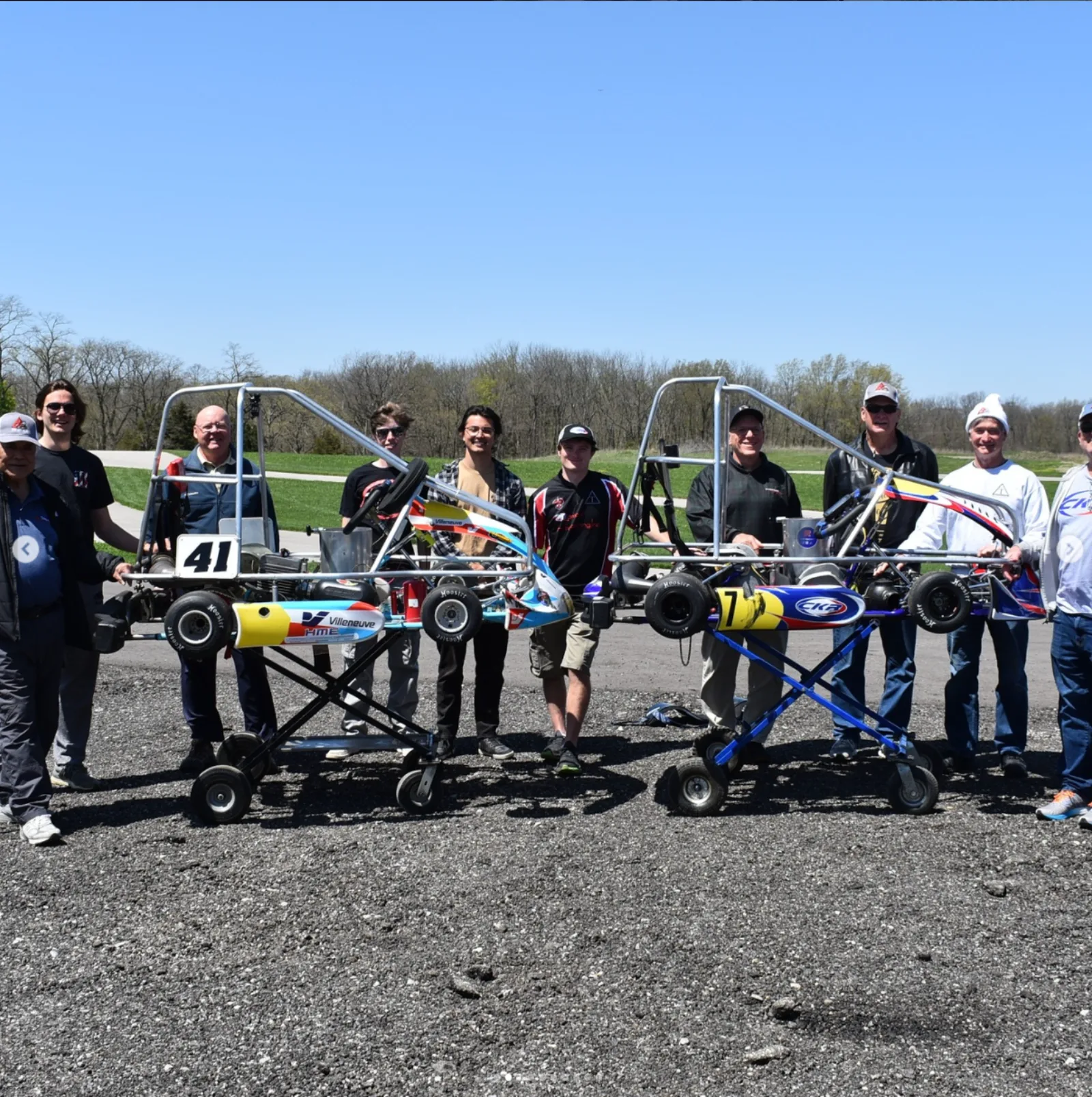 Triangle Racing members and alumni with the karts at the track