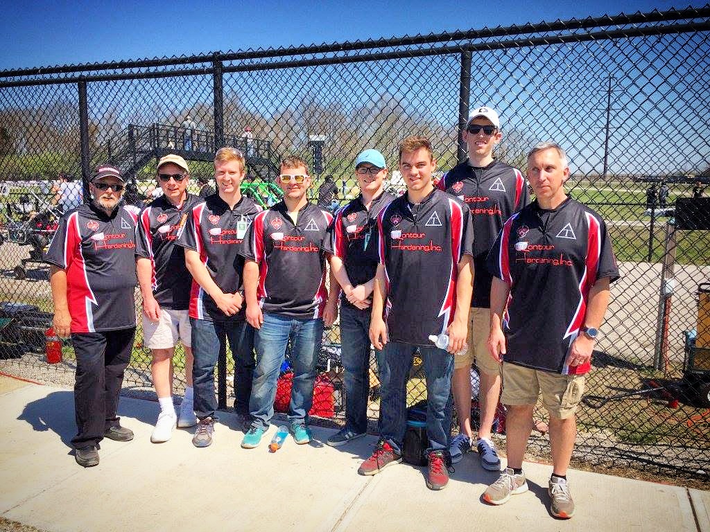 Triangle Racing members working together on the kart