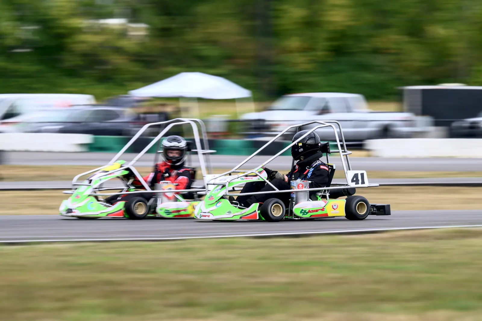 Two Triangle Racing karts at speed on track